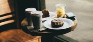 2 coffees with muffin on wood table | hard bean